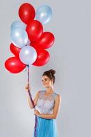 Wwoman wearing beautiful dress with a lot of colorful balloons photo