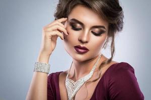 Young gorgeous woman which wearing beautiful jewellery photo