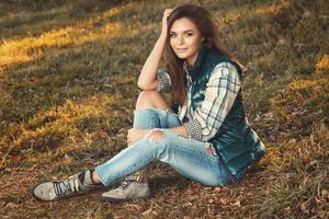 Woman in the park at sunny autumn day photo