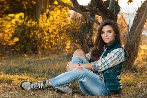 Woman in the park at sunny autumn day photo