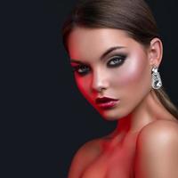 Woman with beautiful earrings in red light photo