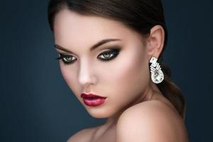 Portrait of young beautiful woman with beautiful earrings photo