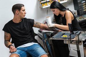 Tattoo artist during her work photo