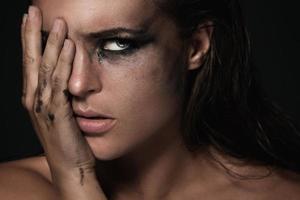 Portrait of beautiful woman with dirty smreaded makeup photo