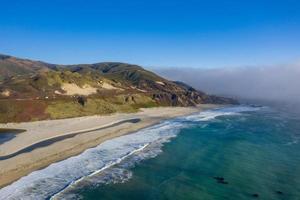 Ocean fog rolling in onto Highway 1 and Big Sur, California, USA photo