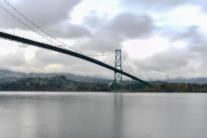 Lions Gate Bridge as seen from Stanley Park in  Vancouver, Canada. The Lions Gate Bridge, opened in 1938, officially known as the First Narrows Bridge, is a suspension bridge. photo