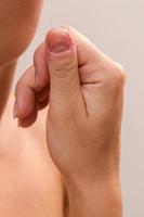 Closeup of injured female finger after biting nails photo