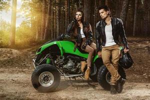 Stylish couple and ATV transport in the forest photo