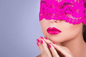 Woman with a pink blindfold on her face photo