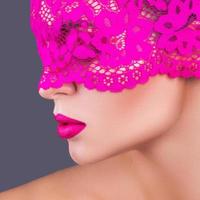 Woman with a pink blindfold on her face photo