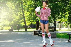 Happy woman on the roller-skate in the park photo