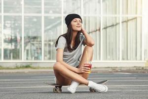 Portrait of beautiful girl with a skateboard photo