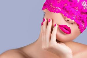 Woman with a pink blindfold on her face photo