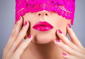 Woman with a pink blindfold on her face photo