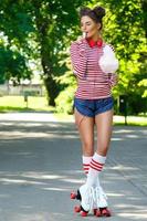 Happy woman on the roller-skate in the park photo