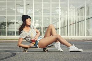 Portrait of beautiful girl with a skateboard photo