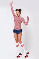 Beautiful woman in the roller-skates in studio photo