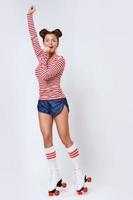 Beautiful woman in the roller-skates in studio photo