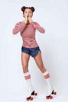 Beautiful woman in the roller-skates in studio photo