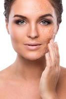 Young beautiful woman with sugar scrub on her face photo