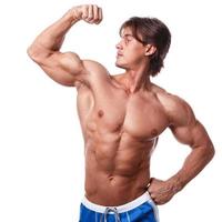 Handsome young muscular man on white background photo