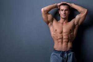 Handsome and muscular man posing in studio photo
