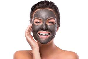 Beautiful woman with a clay or a mud mask on her face photo