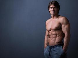 Handsome and muscular man posing in studio photo