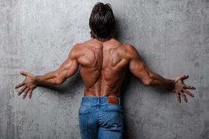 Portrait of Handsome muscle man wearing blue jeans photo