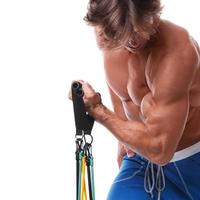 Handsome guy working out with rubber band photo