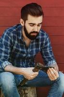 Handsome bearded man in checkered shirt with axe photo