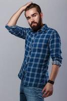 Portrait of handsome bearded man in checkered shirt photo