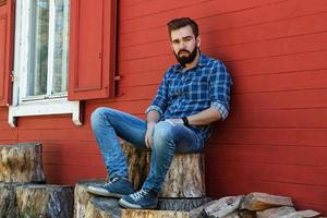 Portrait of handsome bearded man in checkered shirt photo