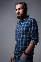 Portrait of handsome bearded man in checkered shirt photo