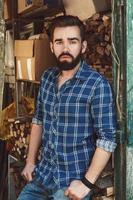 Handsome young bearded man in checkered shirt photo