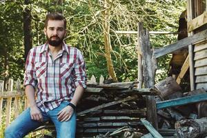 Handsome young bearded man in checkered shirt photo