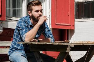 Man is smoking cigarette durring his rest break photo
