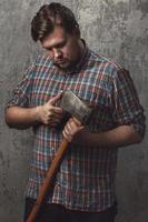 Bearded man with axe posing in studio photo