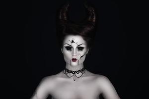 Talking broken doll with horns on her head photo