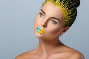 Beautiful woman with yellow hair and colorful nails and lips photo