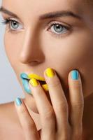 Beautiful woman with colorful nails and lips photo