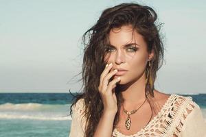 Portrait of young charming woman on the beach photo