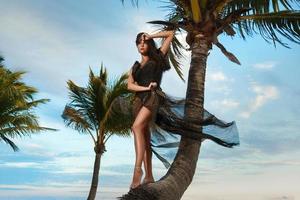 Woman in beautiful dress with leopard print on the beach photo