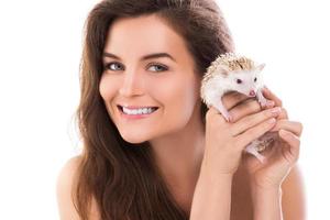 Happy and smiling woman and cute little hedgehog photo