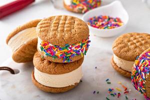 Ice cream and cookies sandwiches stacked on the table photo