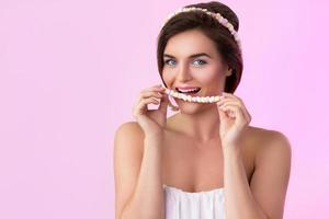 Cute woman and beads made from little marshmallow photo