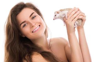 Happy and smiling woman and cute little hedgehog photo