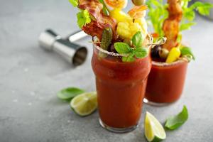 Bloody mary cocktail topped with various garnishes photo