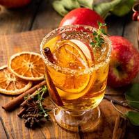 Festive fall cocktail or mocktail with hard cider, apple and orange photo