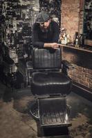 Portrait of stylish hairdresser man in his studio photo
